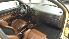 the interior of a car with brown leather seats