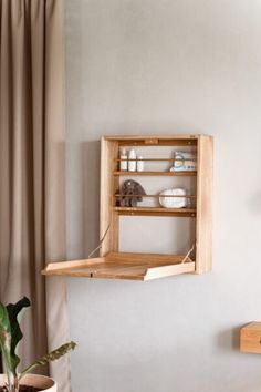 a wooden shelf mounted to the side of a wall