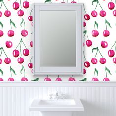 a white sink sitting under a mirror next to a wall