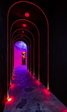 the tunnel is lit up with red and blue lights