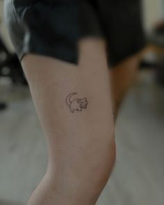 a person with a small tattoo on their left leg and the other arm behind her