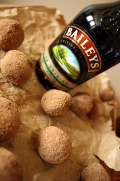 a bottle of beer is being poured into some balls