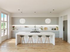 a kitchen with an island and stools in the center, surrounded by large windows