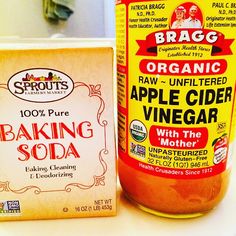 a jar of baking soda next to a box of organic apple cider vinegar and an orange juice