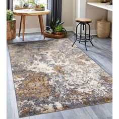 an area rug in a living room with wooden floors