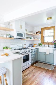 the instagram page on instagram com shows an image of a kitchen with white cabinets and wood floors