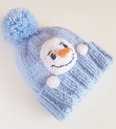 a knitted hat with a snowman face on it