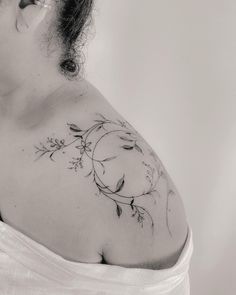 a woman with a tattoo on her shoulder