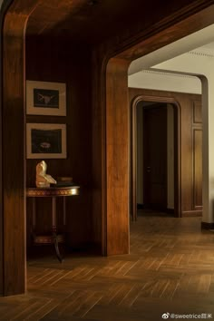 an empty room with wood floors and wooden paneling on the walls is pictured in this image