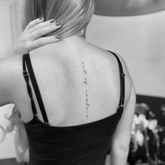 the back of a woman's neck with writing on it