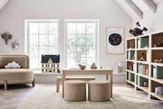 a living room filled with furniture and lots of bookshelves next to a window