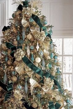 a christmas tree with gold and green decorations