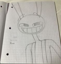 an open notebook with a drawing of a cartoon character