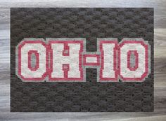 the word ohio is made up of red and white letters on a black background with wood flooring