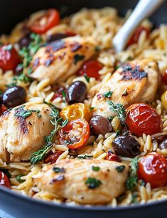 a skillet filled with chicken, tomatoes and olives on top of pasta noodles