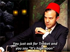 a man sitting at a table with a red hat on top of his head and a quote from the book, you just ask for trinket and you say it's high noon