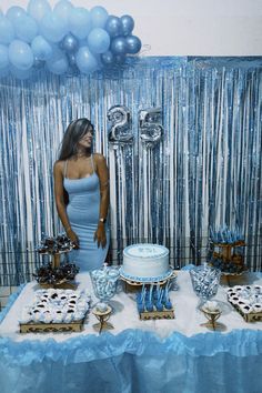 a woman standing in front of a table filled with cake