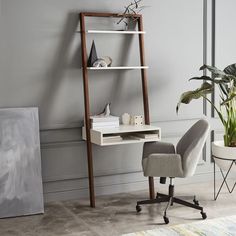 a chair and desk in a room with a ladder leaning against the wall next to a potted plant