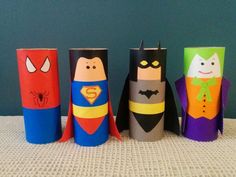 four toilet paper roll crafts with batman, spiderman, and dracula faces on them