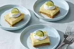 three slices of key lime cheesecake on plates