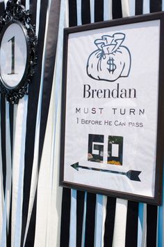 a sign on the side of a building that says brendan must turn 1 before he can pass