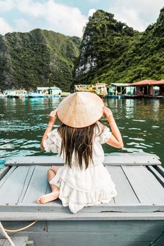 a woman sitting on top of a boat in the water