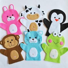 five different animal finger puppets on a white surface