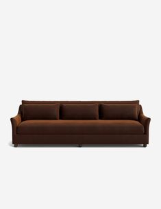 a brown couch sitting on top of a white floor