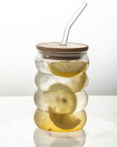 a glass jar filled with sliced lemons and water