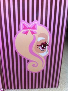 a pink and purple striped bag with a pony on it's face in the center