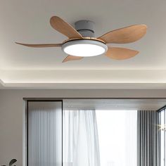 a ceiling fan mounted on the wall above a bed