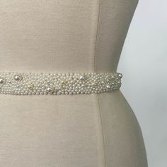 a white belt with pearls on it