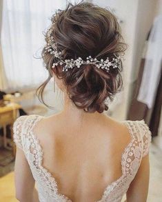 the back of a woman's head wearing a wedding dress