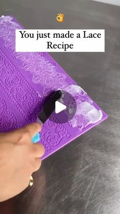 a person is using a knife to cut out a piece of purple paper with the words you just made a lace recipe on it