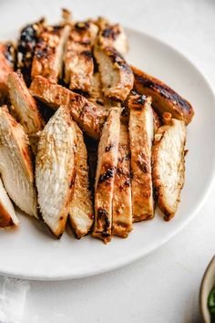 chicken and potatoes on a white plate ready to be eaten