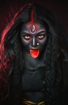 a woman with black makeup and red eyes