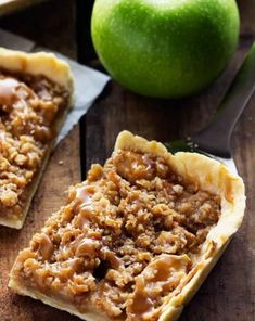 two pieces of pie sitting on top of a wooden table