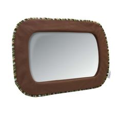 a brown and green square mirror sitting on top of a white wall