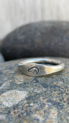 Silver stacking rings are great for everyday ware. This substantial silver bear ring is made with traditional silversmithing techniques and is a great gift for any nature lover. Perfect for both men and women and can be personalized with a stamp of your choice. DETAILS Material: sterling silver Band Thickness: 3.2 mm Available stamp images: shown in photo Bear Swirl Oak Leaf Antler Trinity Symbol Crow Horse Diamond Sizes: made to order in US ring sizes 6-17 Fabrication: 3 business days Shipping: Silver Thumb Rings For Women, Mens Rings Silver, Trinity Symbol, Bear Ring, Silver Ring For Men, Spirit Bear, Chunky Silver Rings, Thumb Rings Silver, Silver Bear