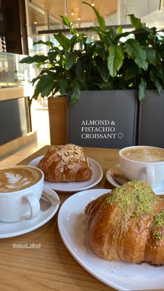 two croissants and coffee are on the table