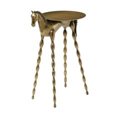 a golden horse shaped table with long legs