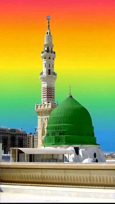 a large green dome on top of a building with a rainbow sky in the background