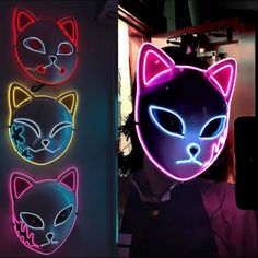 three neon masks with cats on them