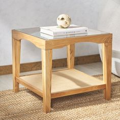 a wooden table with a glass top and two books on it