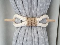 a close up of a curtain with ropes attached to the top and bottom of it