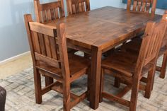 a wooden table and chairs in a room with carpeted flooring on the floor