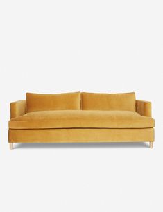 a yellow couch sitting on top of a white floor