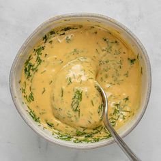 a bowl filled with soup and a spoon in it