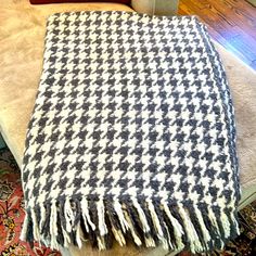 a black and white blanket sitting on top of a couch