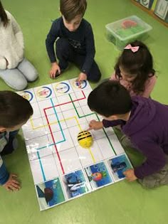 three children playing a board game on the floor